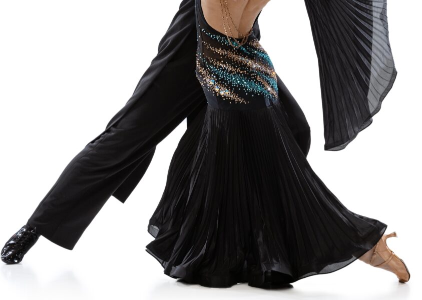 Full-length portrait of young couple practising ballroom dancing isolated over white studio background